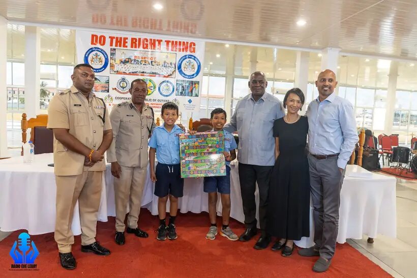Julian and Landon holding the board at the Do the Right Thing event