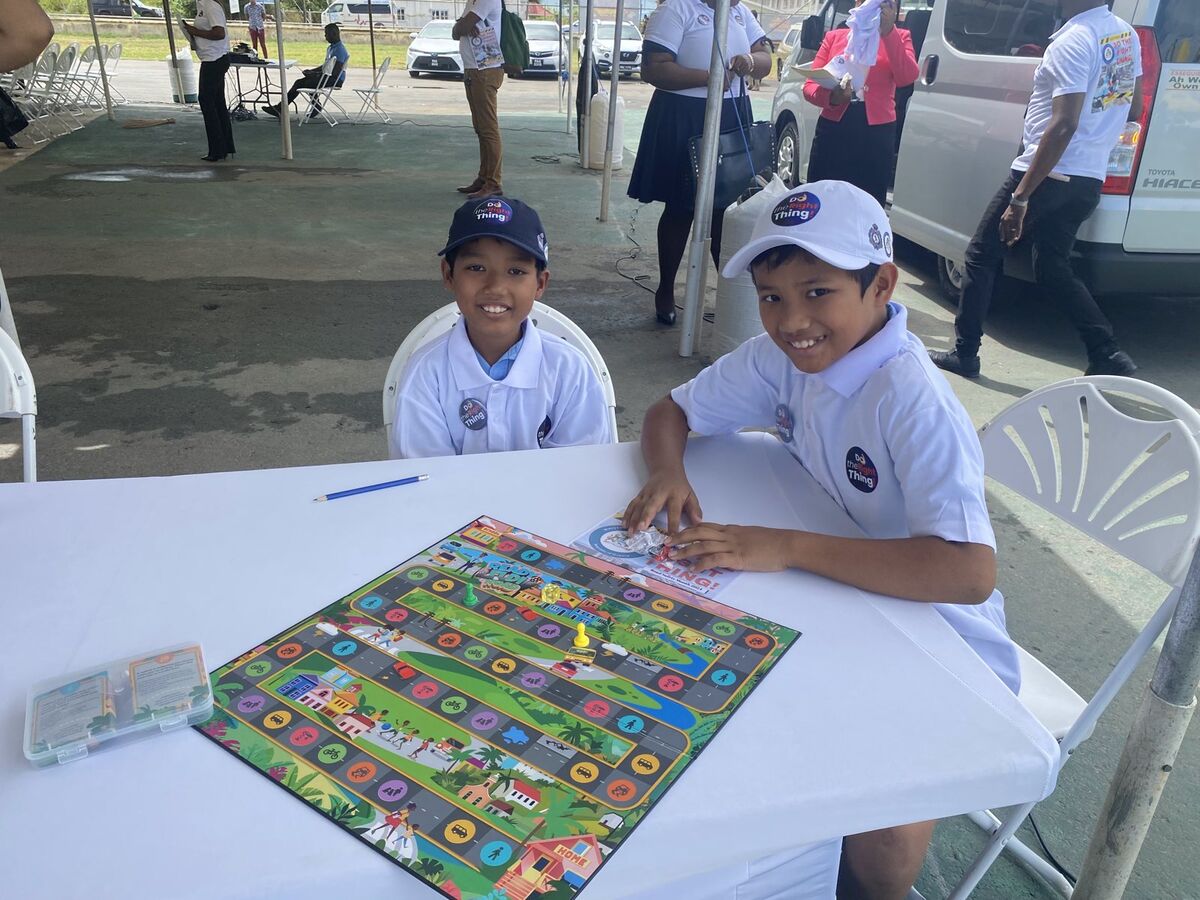 Julian and Landon at a table with the board, ready for players